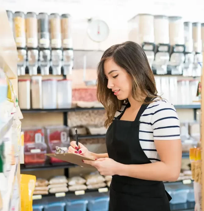 female-owner-checking-inventory-food-products-grocery-store